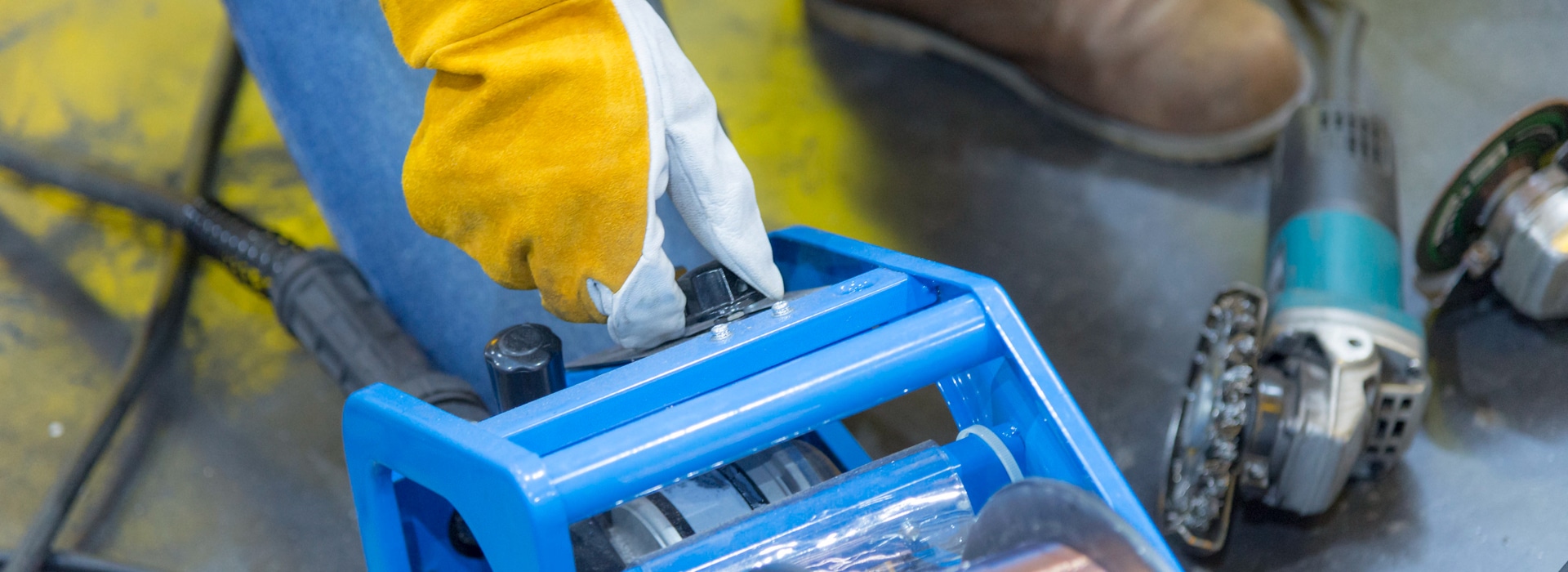 Big Easy Iron Works welder adjusting mobile welding machine for residential iron repair in New Orleans